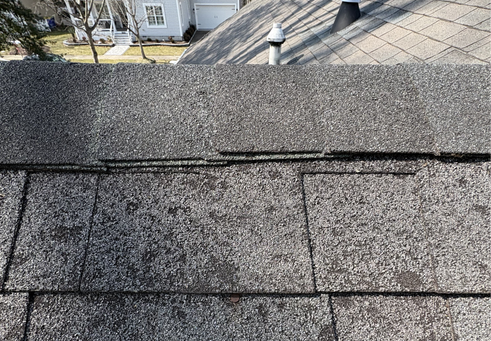 Several asphalt shingles lifted and unsealed along the roof